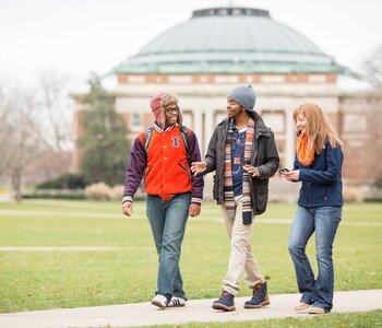 Students walking on sidewalk in front of Foellinger Auditorium