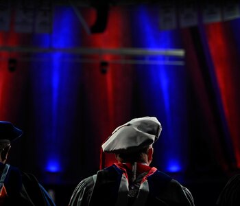 Graduate students gather for their doctoral hooding ceremony as the Graduate College recognizes doctoral degree recipients and their mentors during graduation ceremonies at the State Farm Center.